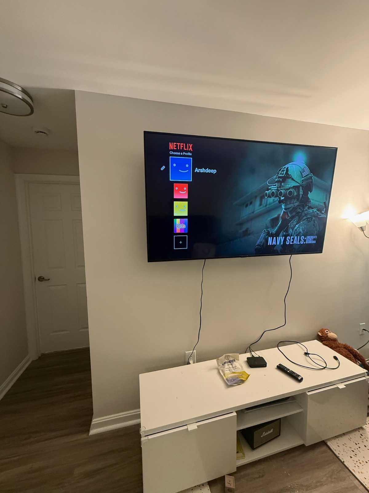 A wall-mounted TV installed level with cables tucked away
